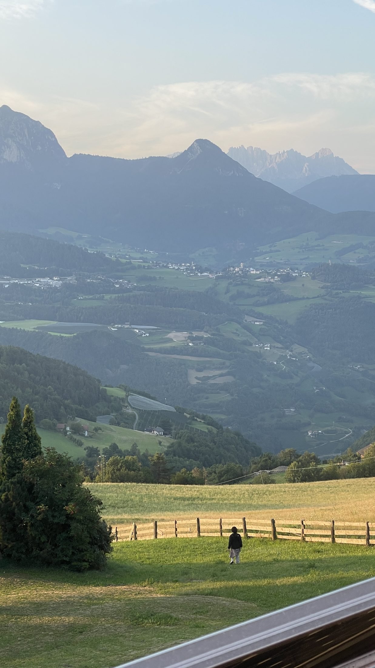 View from the Ritten plateau across green South Tyrolean valleys towards the Dolomites