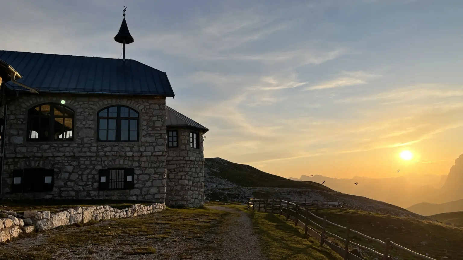 Schlernhaus and its small chapel in golden evening light