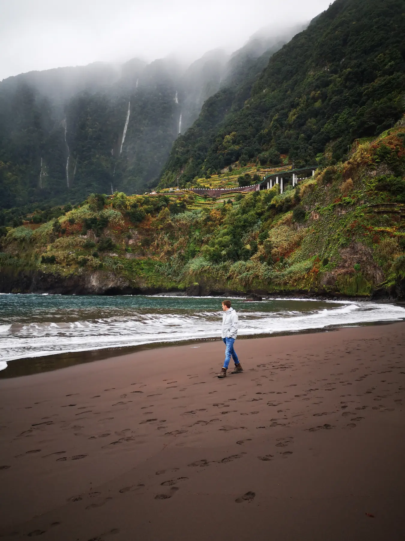Black beach, green cliffs and waterfalls at Seixal in Madeira