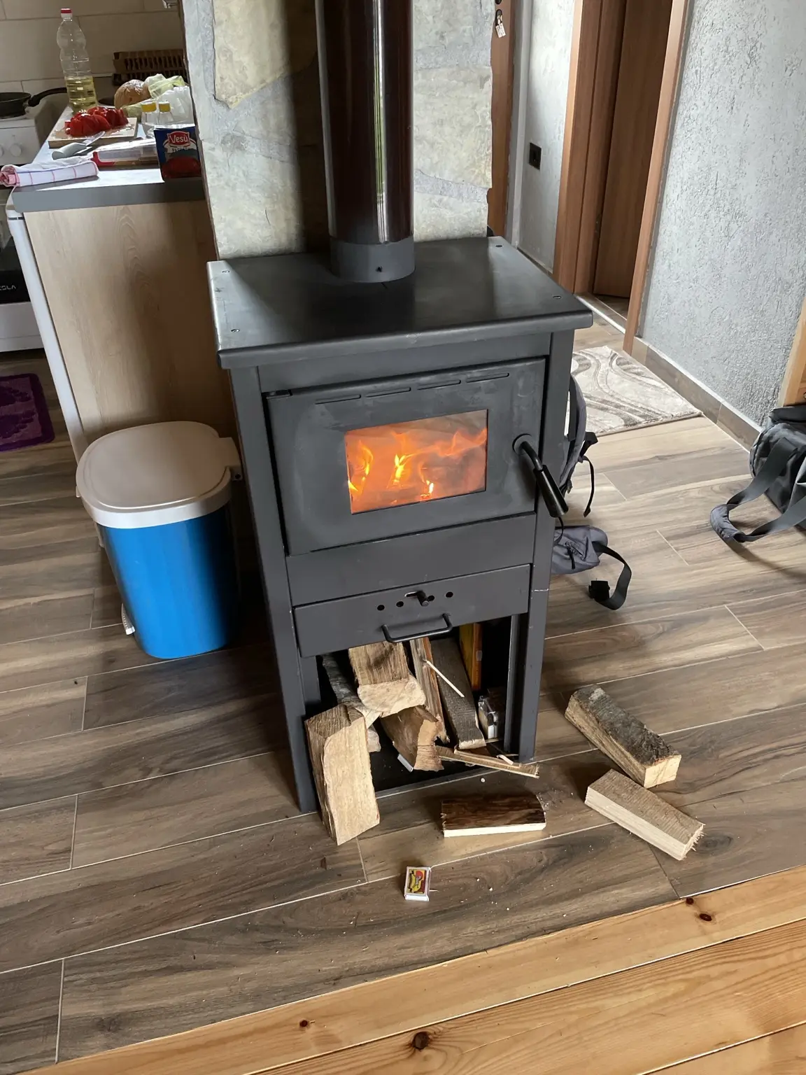 Burning wood stove inside a mountain cabin in Durmitor