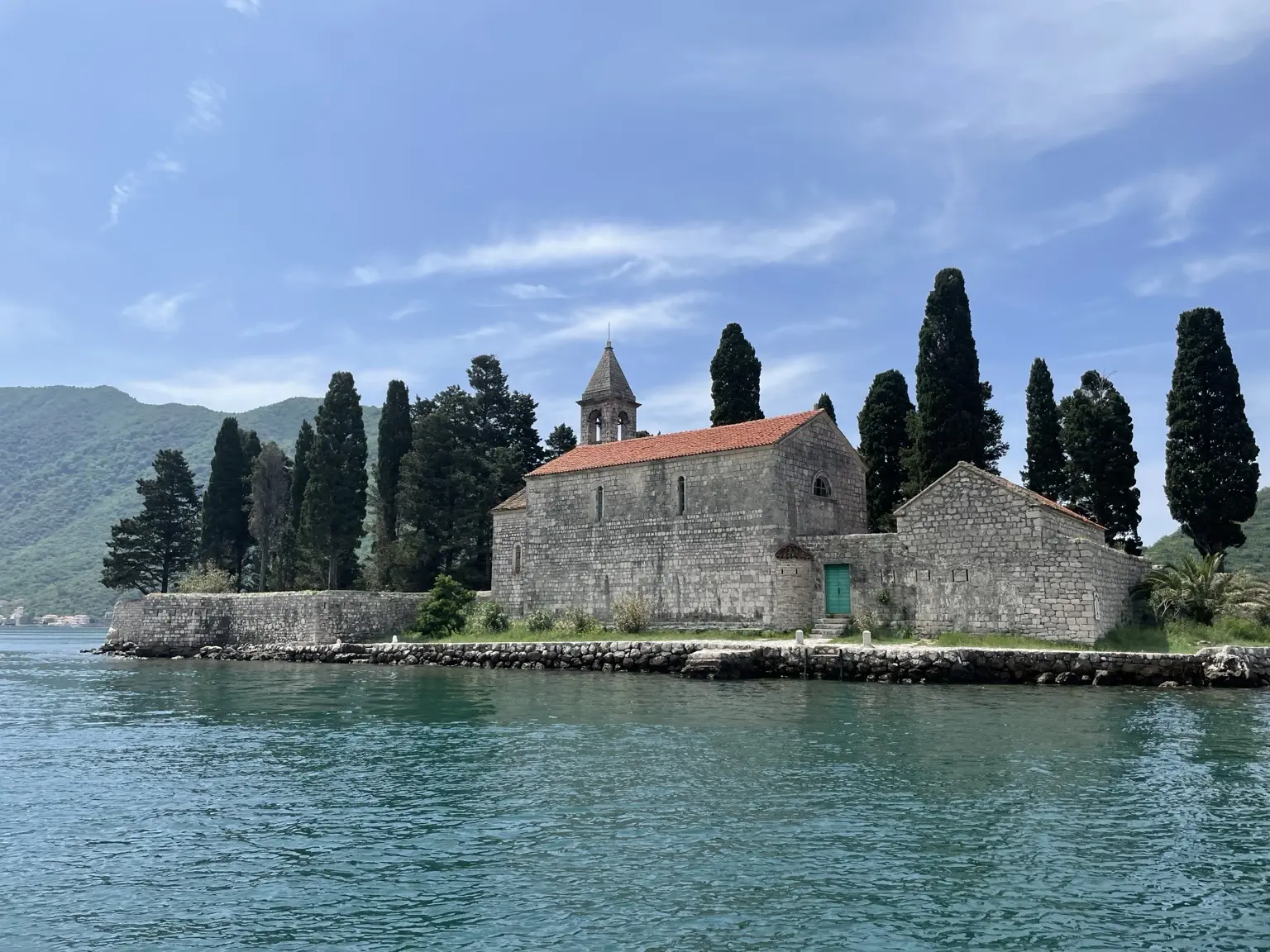 Stone church on a small cypress-covered island off Perast