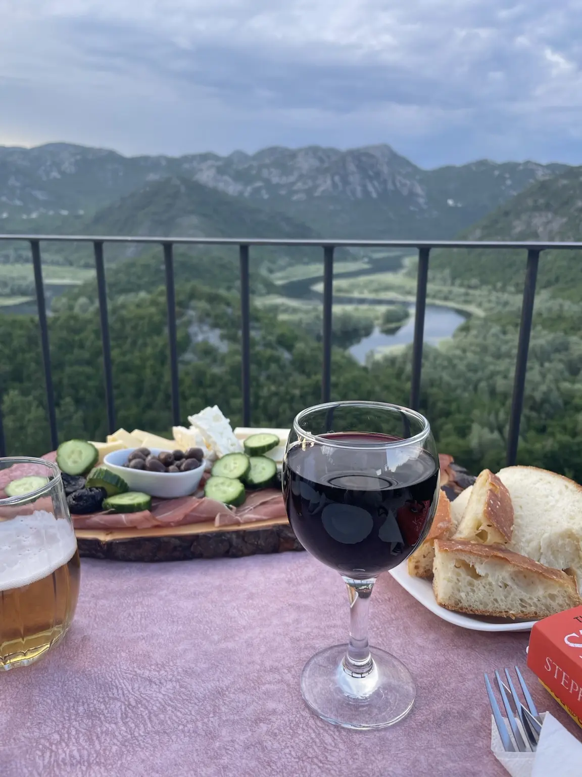 Bread, cheese, olives and wine on a terrace overlooking the bends of the Rijeka Crnojevića